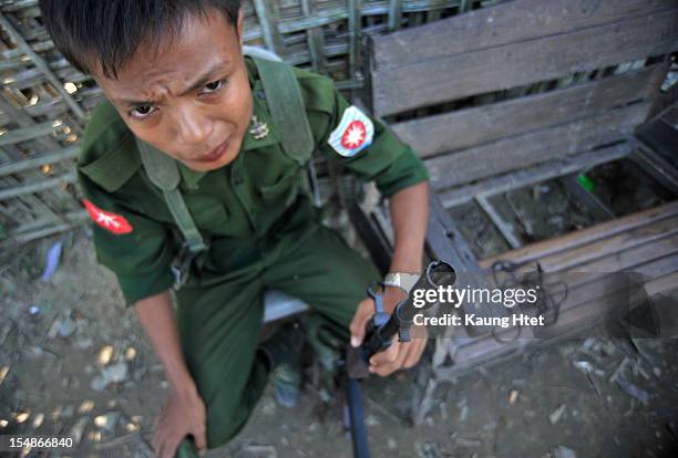Soldier stands guard at quarter No.3 in Pauktaw township, that was burned in recent violence between Buddhist Rakhine and Muslim Rohingya, on October...