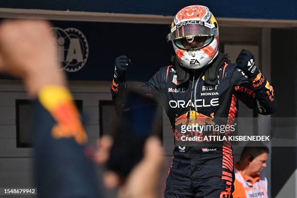 Red Bull Racing's Dutch driver Max Verstappen celebrates winning the Formula One Hungarian Grand Prix at the Hungaroring race track in Mogyorod near...