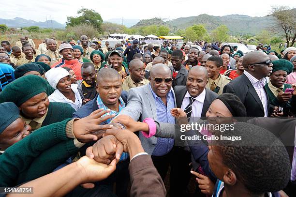 Julius Malema is mobbed by crowds at the funeral of Thomas Madigage, the assistant coach of South Africa's national soccer team, in Driekop on...
