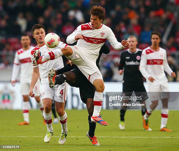 Olivier Occean of Frankfurt is challenged by William Kvist and Gotoku Sakai of Stuttgart during the Bundesliga match between VfB Stuttgart and...