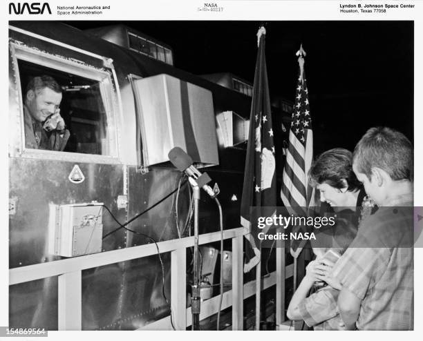 American astronaut Neil Armstrong , commander of the Apollo 11 lunar mission, talks to his wife Jan and sons Mark and Eric from the Mobile Quarantine...