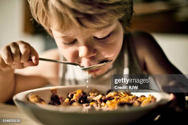 child eating cereal - colazione bambini foto e immagini stock