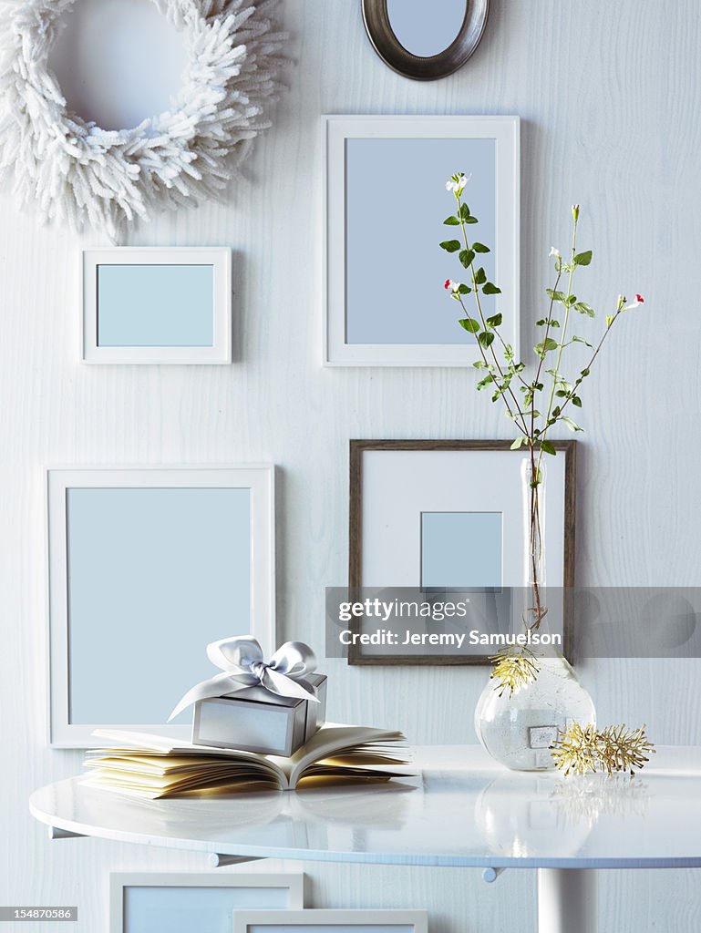 Frames on Wall with Present on Table