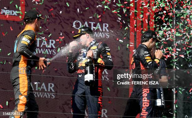 Second placed McLaren's British driver Lando Norris, winner Red Bull Racing's Dutch driver Max Verstappen and third placed Red Bull Racing's Mexican...