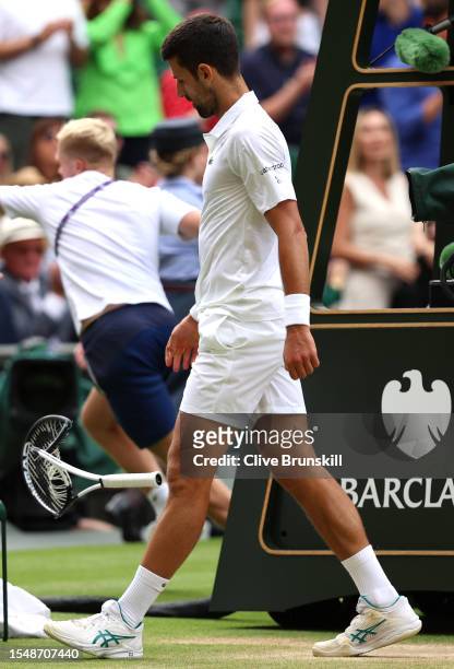 Novak Djokovic of Serbia smashes his racket during the Men's Singles Final against Carlos Alcaraz of Spain on day fourteen of The Championships...