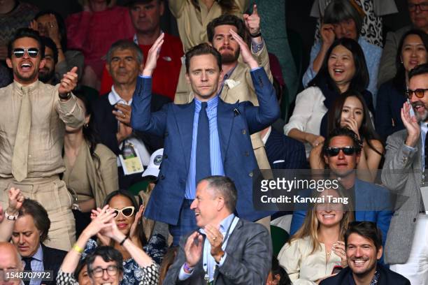 Tom Hiddleston cheers while watching Carlos Alcaraz vs Novak Djokovic in the Wimbledon 2023 men's final on Centre Court during day fourteen of the...