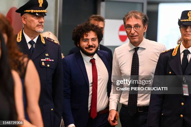 Egyptian activist Patrick Zaki walks next to the rector of the University of Bologna, Giovanni Molari, upon his arrival at Malpensa Airport, near...
