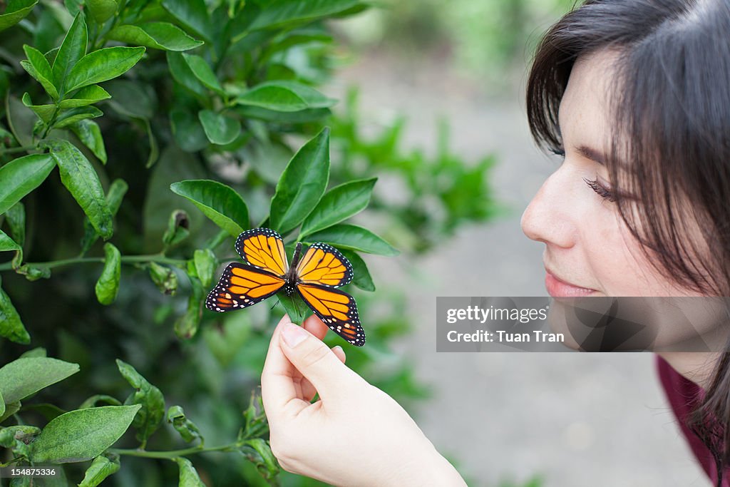 Woman looking at butterfly