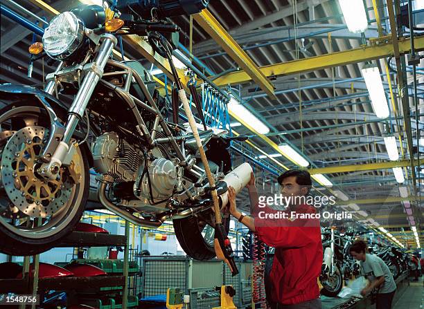 Worker puts the final touches on a fully produced Ducati "Monster" at the Ducati factory September 12, 2002 in Borgo Panigale- Bologna, Italy....