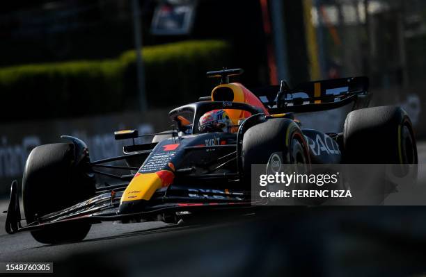 Red Bull Racing's Dutch driver Max Verstappen races to win the Formula One Hungarian Grand Prix at the Hungaroring race track in Mogyorod near...