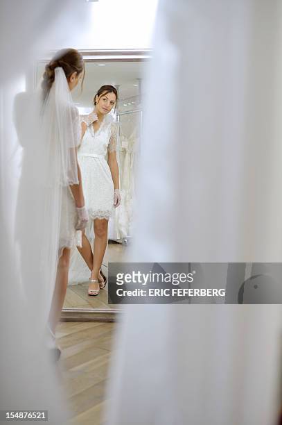 Model presents a wedding dress of Metal Flaque on October 26, 2012 in Paris. From "Kate"-inspired lace dresses to towering wedding cakes -- and even...
