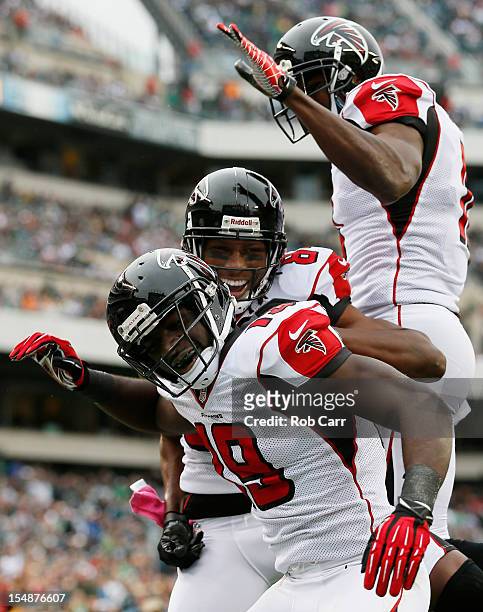 Wide receiver Drew Davis of the Atlanta Falcons celebrates with teammates Roddy White and Julio Jones after catching a first quarter touchdown pass...
