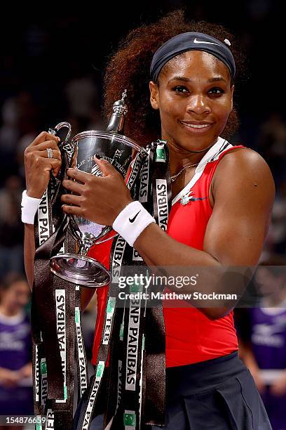 Serena Williams of the United States poses for photographers with the Billie Jean King Trophy after defeating Maria Sharapova of Russia during the...