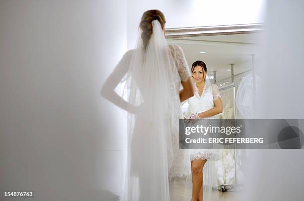 Model presents a wedding dress of Metal Flaque on October 26, 2012 in Paris. From "Kate"-inspired lace dresses to towering wedding cakes -- and even...