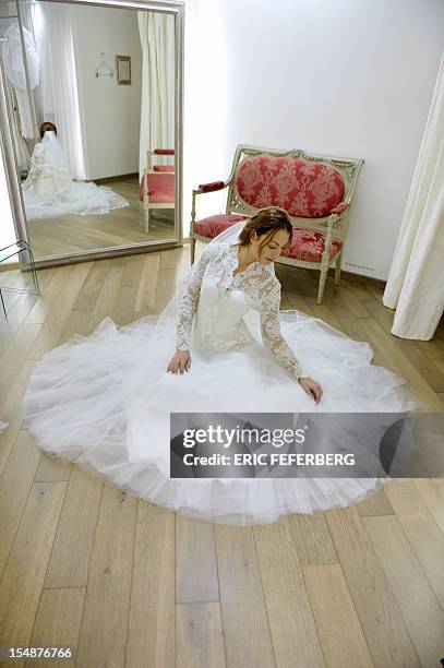 Model presents a wedding dress of Metal Flaque on October 26, 2012 in Paris. From "Kate"-inspired lace dresses to towering wedding cakes -- and even...