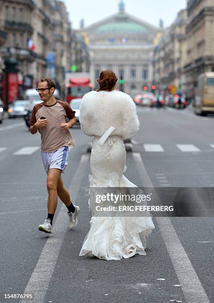 Model presents a wedding dress of Metal Flaque on October 26, 2012 in front of the Opera on October 26, 2012 in Paris. From "Kate"-inspired lace...