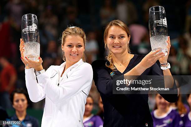 Maria Kirilenko and Nadia Petrova of Russia pose for photographers after defeating Lucie Hradecka and Andrea Hlavackova of Czech Republic during the...