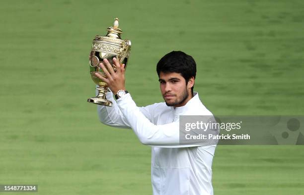 Carlos Alcaraz of Spain lifts the Men's Singles Trophy following his victory in the Men's Singles Final against Novak Djokovic of Serbia on day...