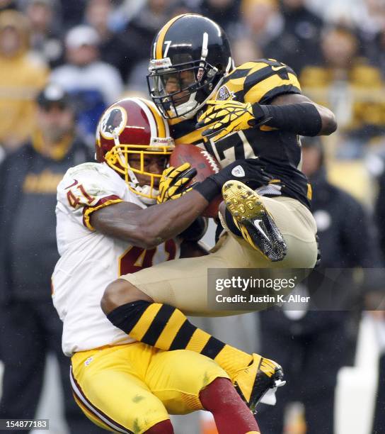 Mike Wallace of the Pittsburgh Steelers makes a catch and is hit by Madieu Williams of the Washington Redskins during the game on October 28, 2012 at...