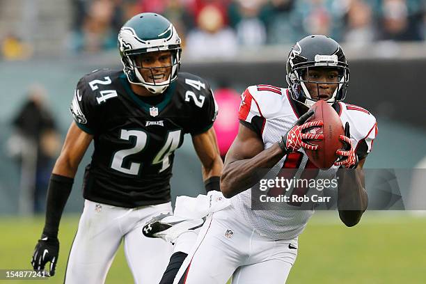 Wide receiver Julio Jones of the Atlanta Falcons catches a pass for a second quarter touchdown in front of cornerback Nnamdi Asomugha of the...