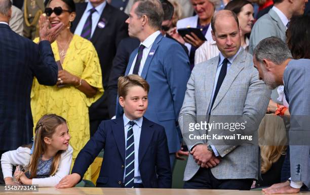Princess Charlotte of Wales, Prince George of Wales and Prince William, Prince of Wales speak with King Felipe VI of Spain after Carlos Alcaraz wins...