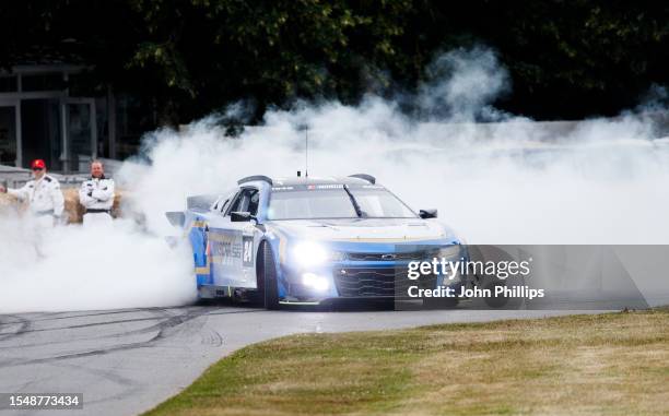 Jenson Button prepares to drive the NASCAR Garage 56 car up the 1.16 mile hill climb during Day 4 of the Goodwood Festival of Speed at Goodwood on...