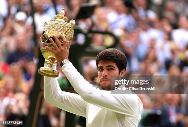 Carlos Alcaraz of Spain lifts the Men's Singles Trophy following his victory in the Men's Singles Final against Novak Djokovic of Serbia on day...