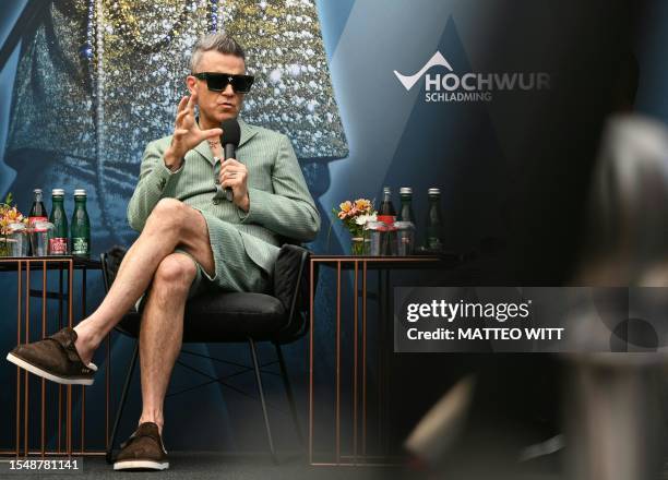 British singer and songwriter Robbie Williams speaks during a press conference on July 23, 2023 in Schladming, Austria, to promote his Ski-Opening...