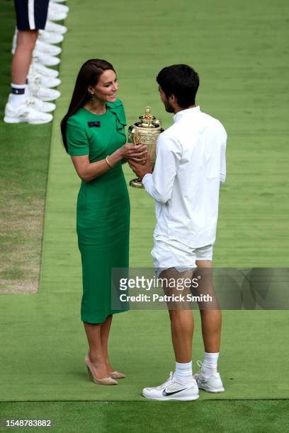 Carlos Alcaraz of Spain recieves the Men's Singles Trophy from Catherine, Princess of Wales following his victory in the Men's Singles Final against...