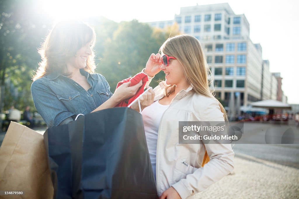 Girlfriends enjoy shopping in city.