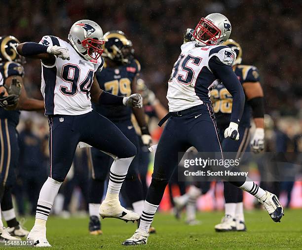 Justin Francis of the New England Patriots and Chandler Jones of the New England Patriots celebrate after sacking the quarterback during the NFL...