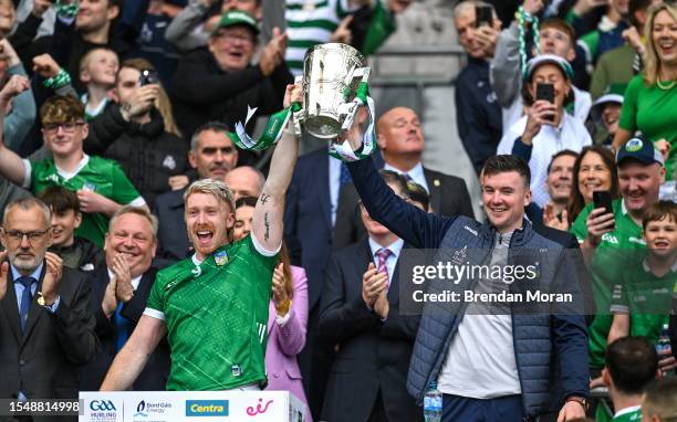 Dublin , Ireland - 23 July 2023; Limerick players Cian Lynch, left, and Declan Hannon lift the Liam MacCarthy Cup after his side's victory in the GAA...