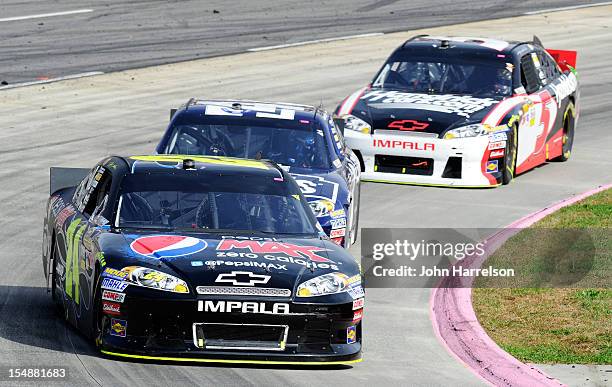 Jeff Gordon, driver of the Pepsi Max Chevrolet, leads Jimmie Johnson, driver of the Lowe's Chevrolet, and Kasey Kahne, driver of the HendrickCars.com...