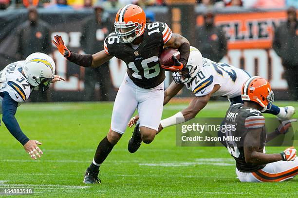 Free safety Eric Weddle and cornerback Antoine Cason of the San Diego Chargers try to tackle wide receiver Josh Cribbs of the Cleveland Browns during...