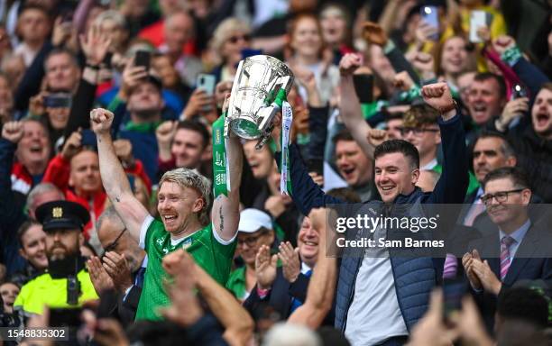 Dublin , Ireland - 23 July 2023; Limerick players Cian Lynch, left, and Declan Hannon lift the Liam MacCarthy after his side's victory in the GAA...