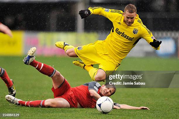 Terry Dunfield of Toronto FC slides in to kick the ball away from Josh Williams of the Columbus Crew in the first half on October 28, 2012 at Crew...