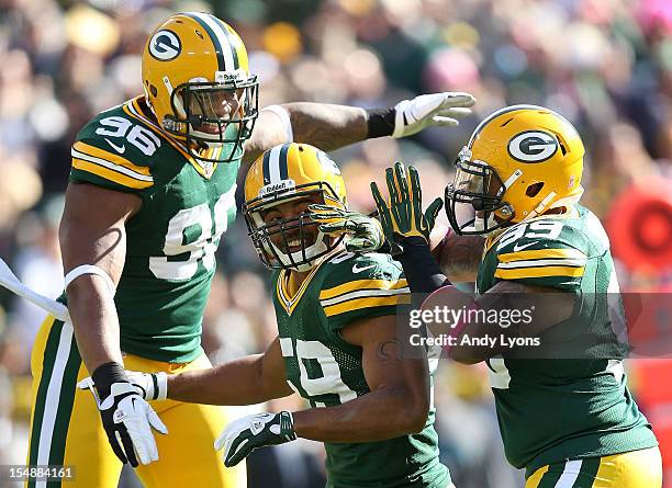 Mike Neal Brad Jones and Jerel Worthy of the Green Bay Packers celebrate during the NFL game against the Jacksonville Jaguars at Lambeau Field on...