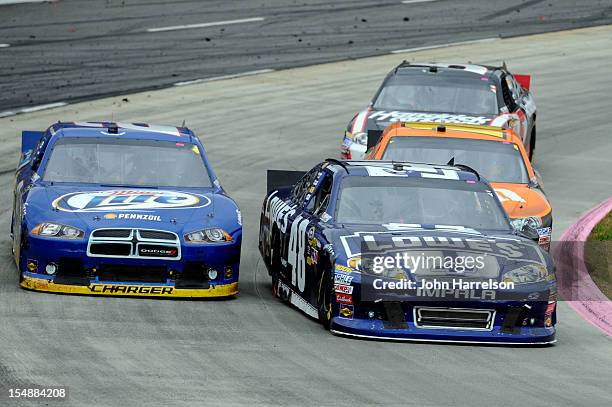 Jimmie Johnson, driver of the Lowe's Chevrolet, passes Brad Keselowski, driver of the Miller Lite Dodge, for the lead during the NASCAR Sprint Cup...