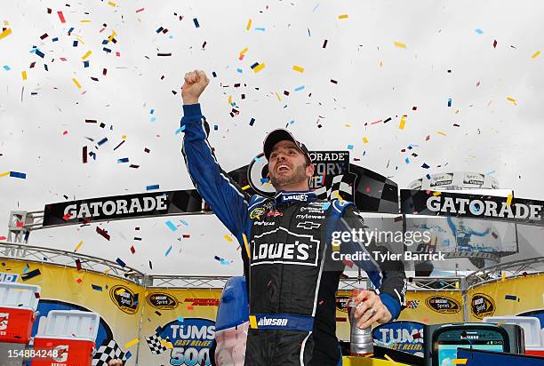 Jimmie Johnson, driver of the Lowe's Chevrolet, celebrates in Victory Lane after winning the NASCAR Sprint Cup Series Tums Fast Relief 500 at...