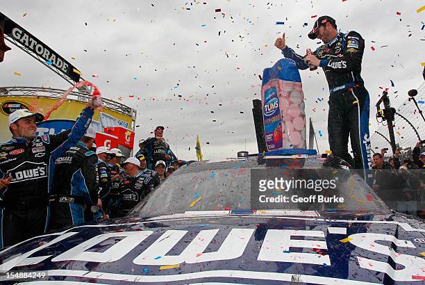 Jimmie Johnson, driver of the Lowe's Chevrolet, celebrates in Victory Lane after winning the NASCAR Sprint Cup Series Tums Fast Relief 500 at...