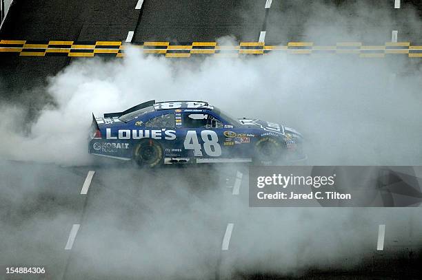 Jimmie Johnson, driver of the Lowe's Chevrolet, celebrates with a burnout after winning the NASCAR Sprint Cup Series Tums Fast Relief 500 at...