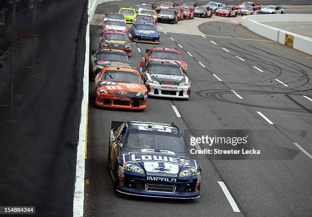 Jimmie Johnson, driver of the Lowe's Chevrolet, leads a group of cars during the NASCAR Sprint Cup Series Tums Fast Relief 500 at Martinsville...