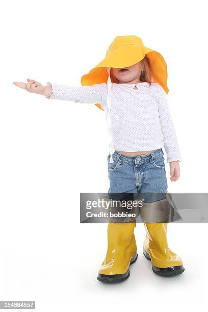 big shoe children:  little girl in rain wear - rain hat stock pictures, royalty-free photos & images