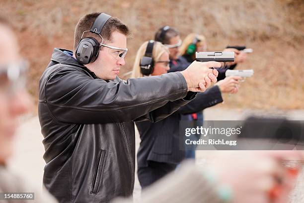 practicing at the shooting range - handgun stockfoto's en -beelden