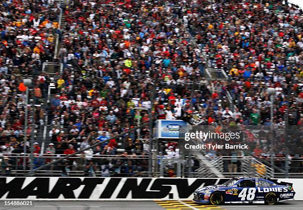 Jimmie Johnson, driver of the Lowe's Chevrolet, races to the checkered flag to win the NASCAR Sprint Cup Series Tums Fast Relief 500 at Martinsville...