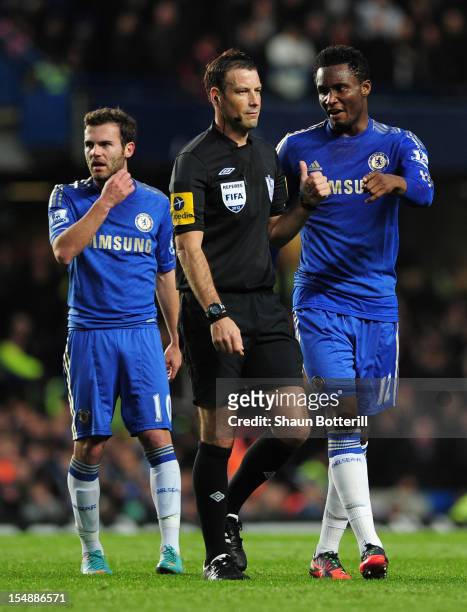 John Obi Mikel of Chelsea talks to referee Mark Clattenburg as team mate Juan Mata looks on during the Barclays Premier League match between Chelsea...
