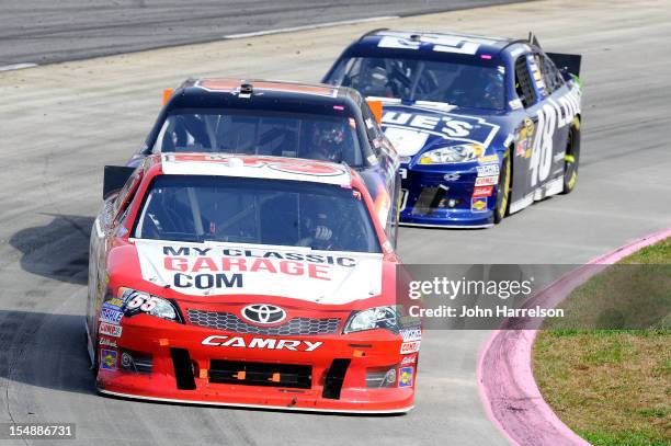 Brian Vickers, driver of the MyClassicGarage.com Toyota, leads Denny Hamlin, driver of the FedEx Express Toyota, and Jimmie Johnson, driver of the...