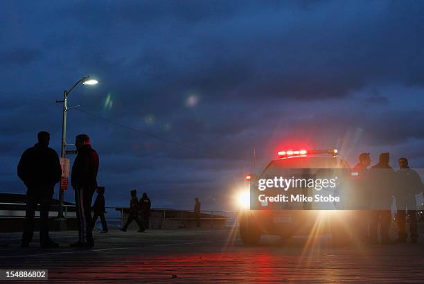 Long Beach police patrol the boardwalk as Hurricane Sandy approaches on October 28, 2012 in Long Beach, New York. Sandy,which has already claimed...