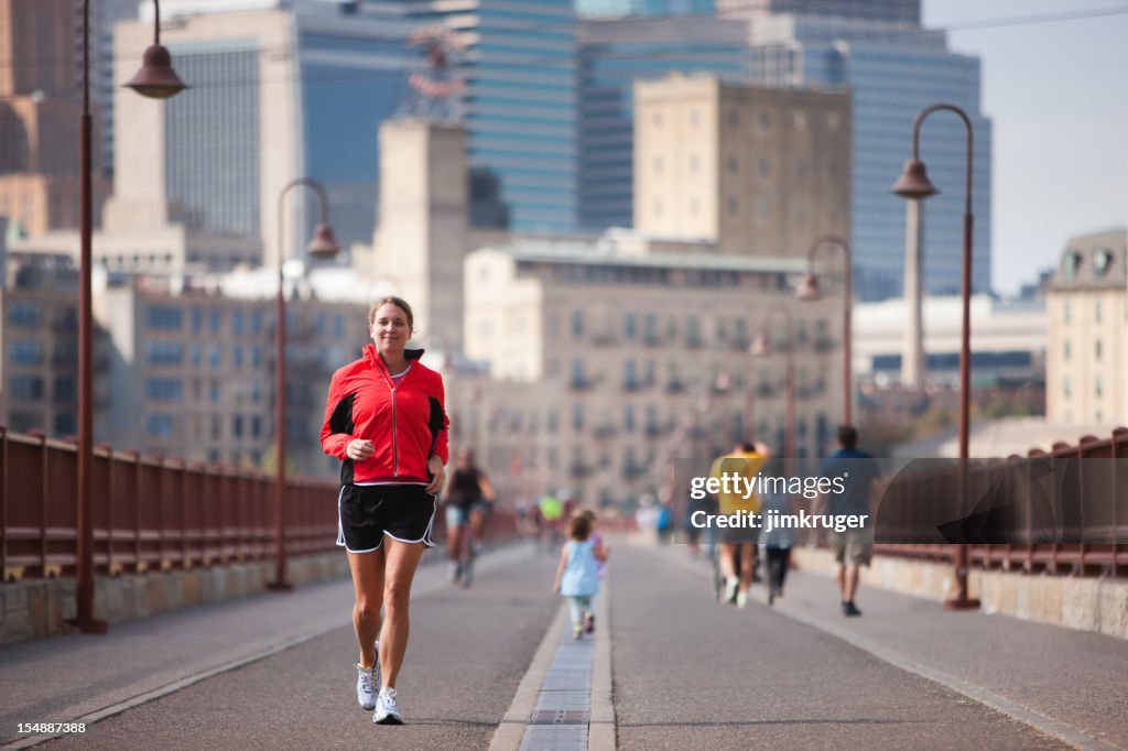 Jogger crossing Minneapolis' famous stone arch bridge.