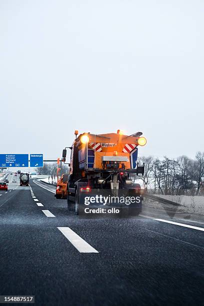 winter service in action - laying road salt on autobahn - road salt 個照片及圖片檔